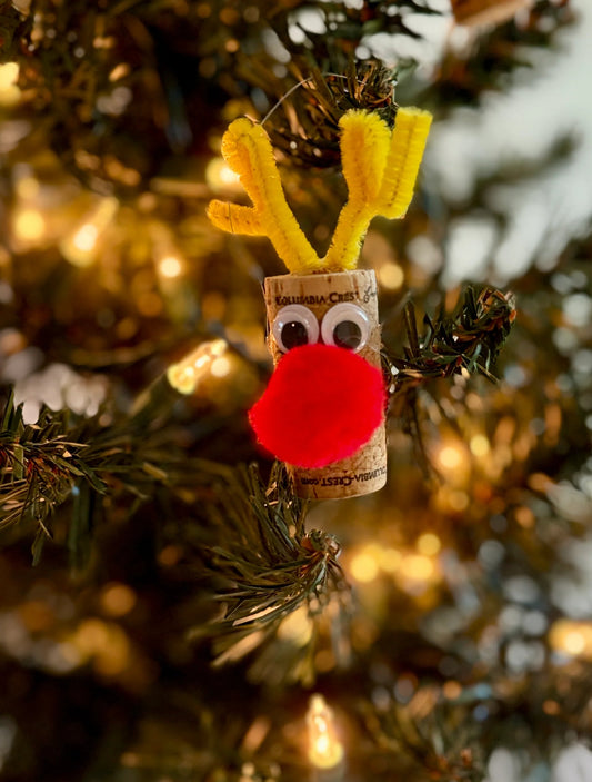 close up of ornament using wine cork to make reindeer ornament with yellow antlers, eyes and big red nose