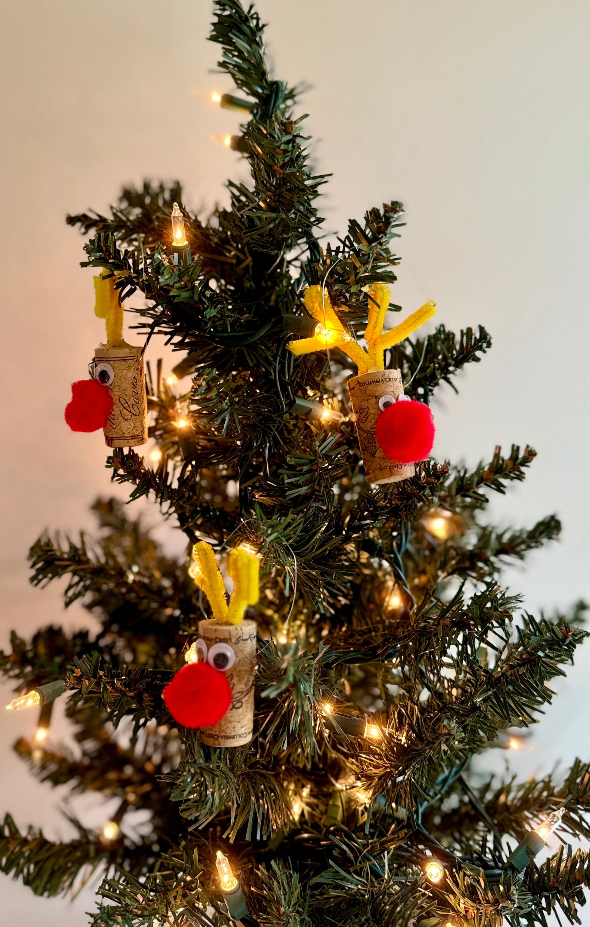 christmas tree with reindeer ornaments made fro wine cork, yellow pipe-cleaners for antlers, eyes and big red nose.  Approximately 1-2 inches in height 